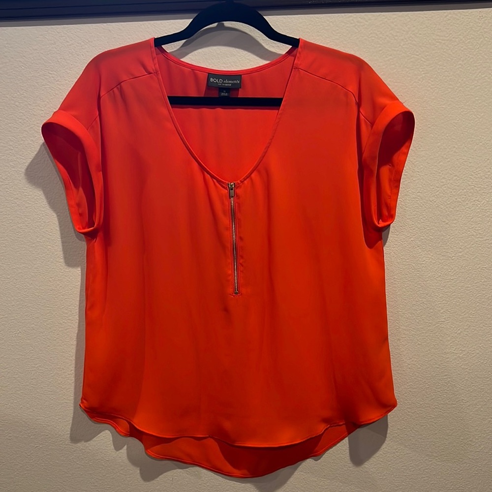 Orange zip front blouse.